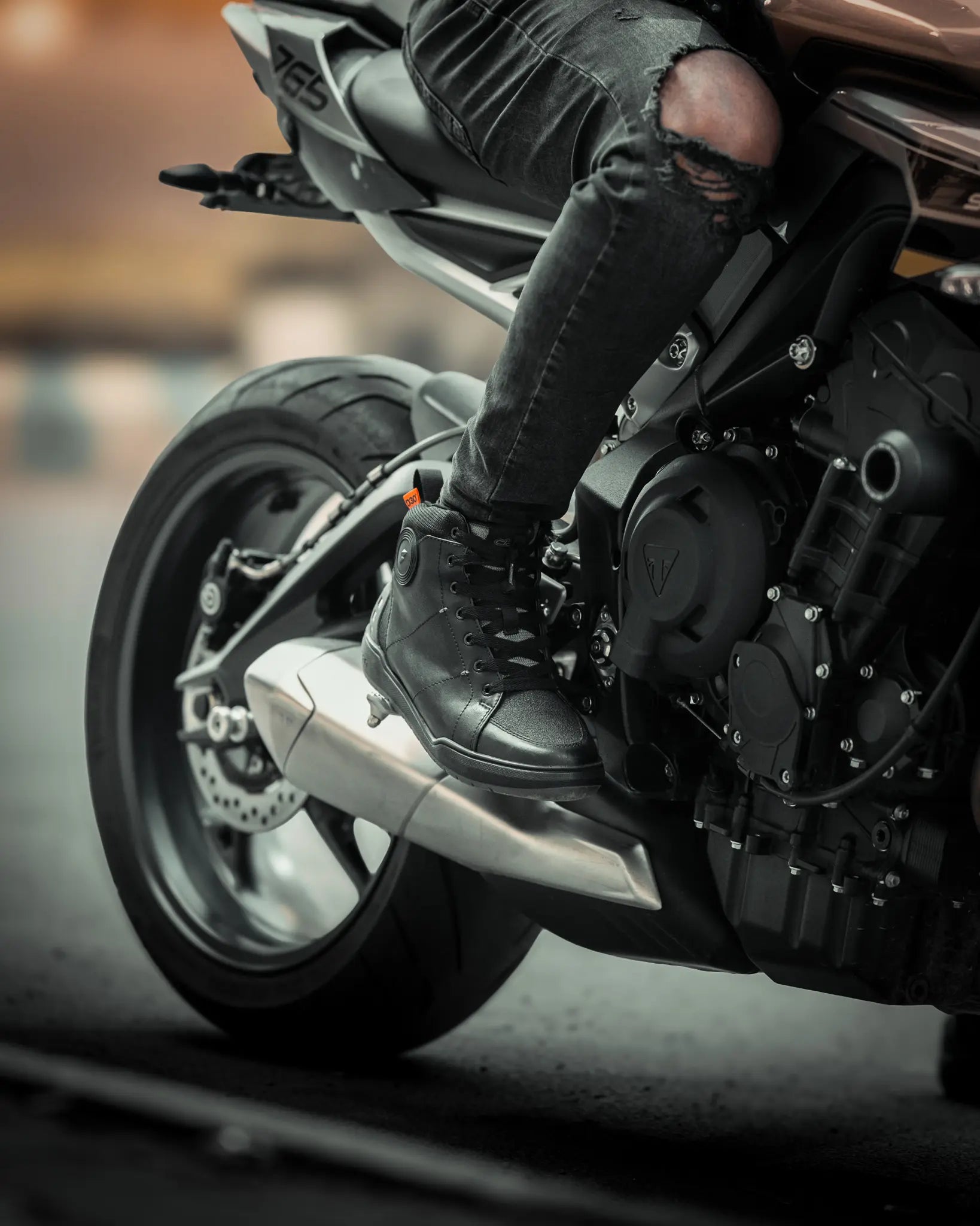 Clan Scout riding shoe lifestyle photograph beside a motorcycle