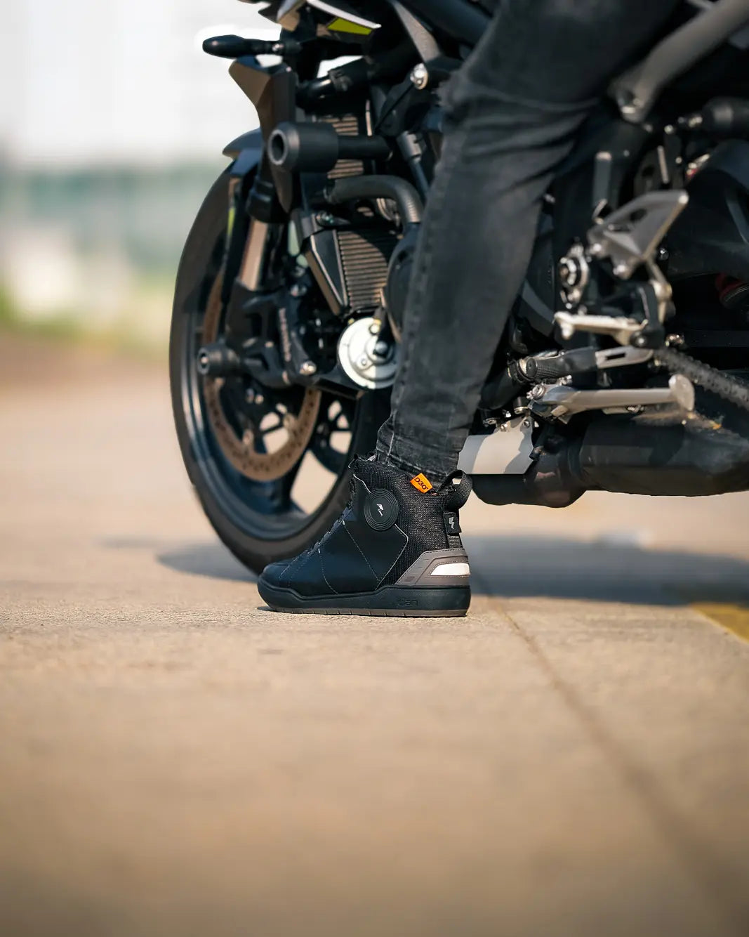 Clan Scout riding shoe photographed around a motorcycle
