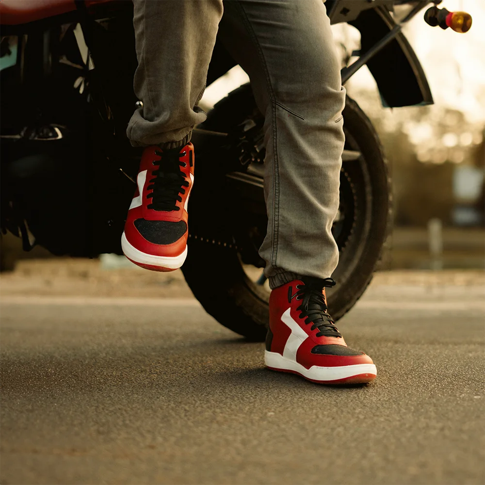 Sealth D30 white red shoes with white accents worn by a person on a motorcycle.