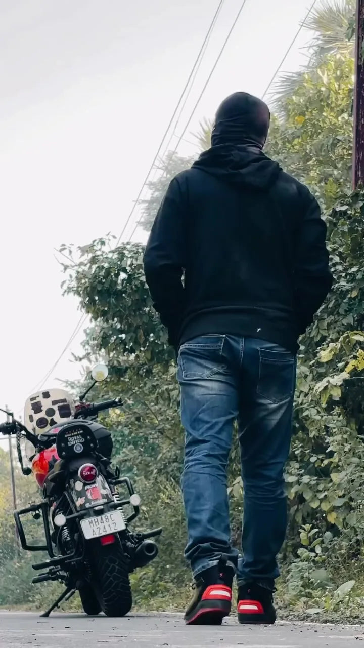 Rider walking towards a motorcycle in Clan Scout riding shoes