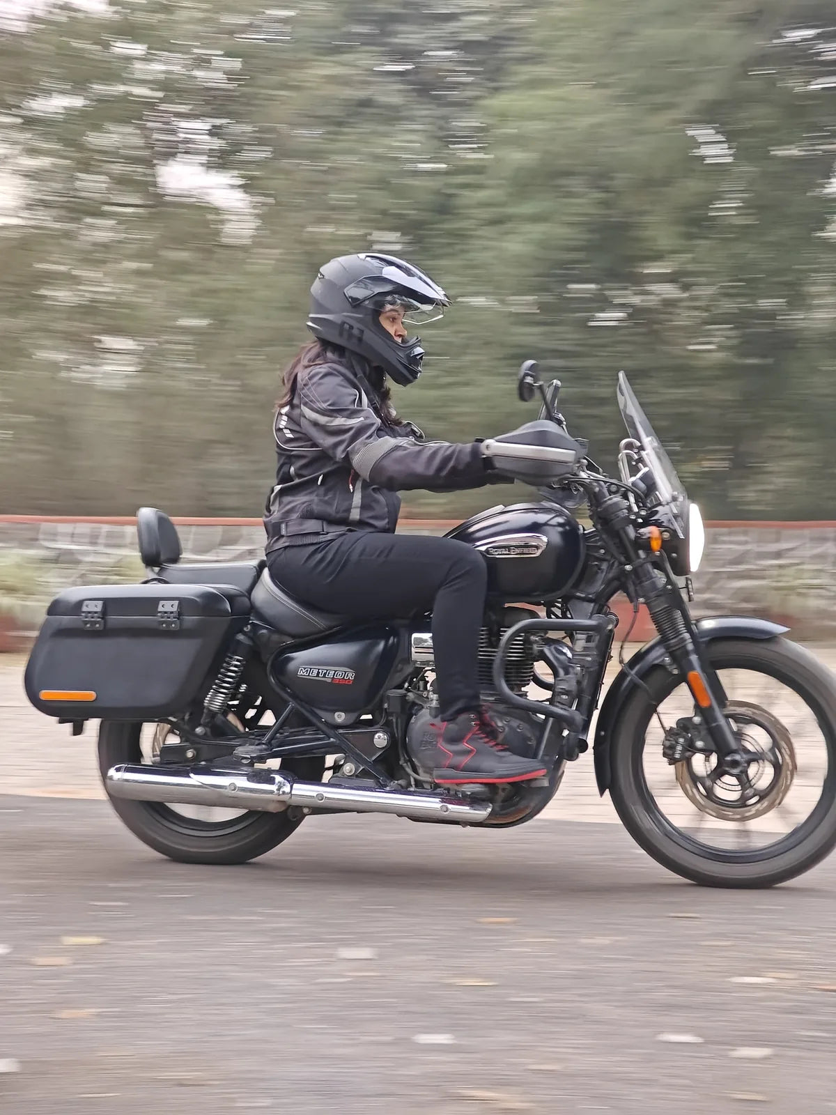 Woman rider wearing Clan Stealth riding shoes while riding her motorcycle