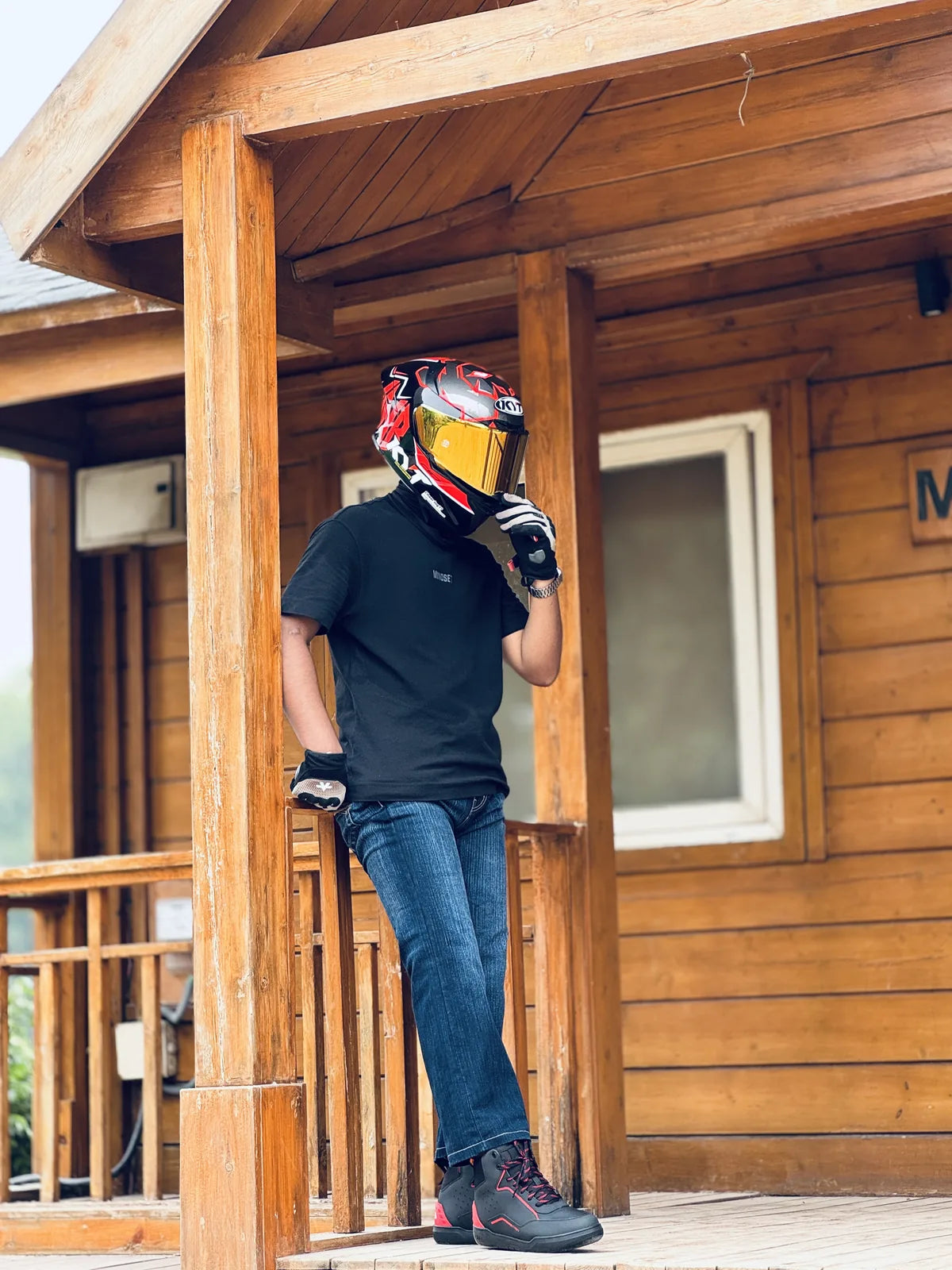 Motorcyclist wearing Clan Torque riding shoes beside a motorcycle
