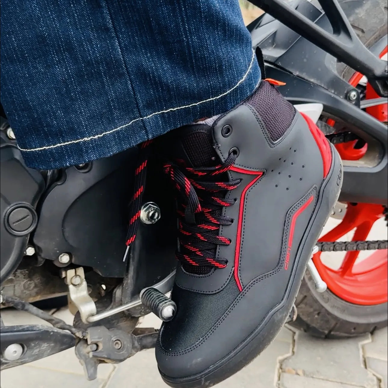 Clan Torque red riding shoes worn on a motorcycle
